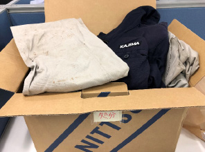 fig: Packing used work clothes into cardboard boxes for shipment