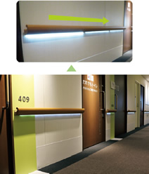 写真：「UD2　五感へ伝えるサイン」で紹介した西葛西・井上眼科病院の病棟廊下では手すりに照明が組み込まれ，非常時には光が避難方向を示すように点滅し，安全な出口へ誘導するサインとなる