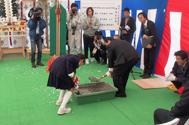 図版：連結式で最終コンクリート投入を行う仁志田伊達市長（右）と月舘小学校の児童代表