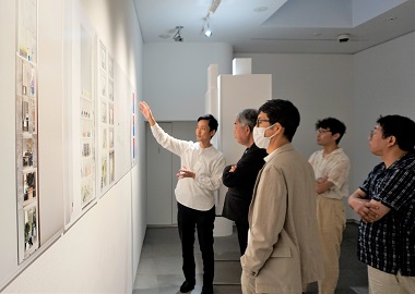 A finalist speaking to judges about their works