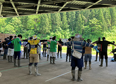 Image: Doing stretches during a lunch break with a local soccer team