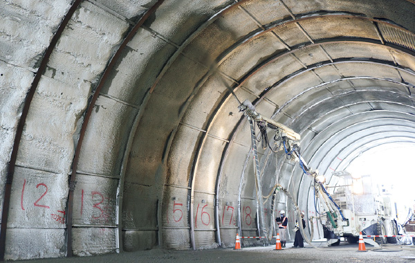 図版：模擬トンネル内でのコンクリート吹付け作業の自動化検証実験