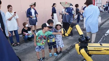 沿道の子どもたちに挨拶をするSpot