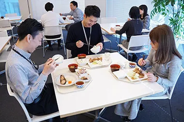 社員食堂で新米を味わう社員