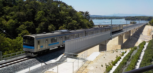 図版：完成した高架橋を通過する仙石線の列車
