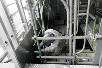 写真：工事用エレベータシャフト内へ雨水侵入防止のための鉄板解体の様子です。